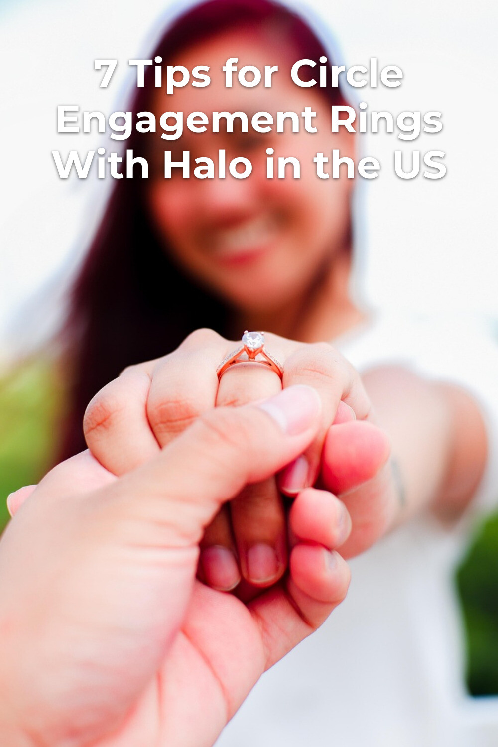 Circle Engagement Ring with Halo in Handhold Circle engagement rings with halo on hand held by partner, bride in white dress blurred in background