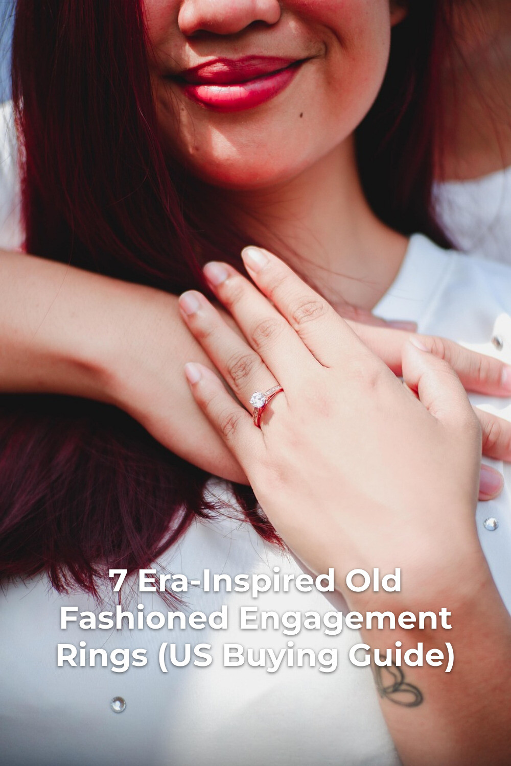 Old Fashioned Engagement Ring Close-Up Old fashioned engagement rings on woman with red lipstick and small wrist tattoo, hands near chest