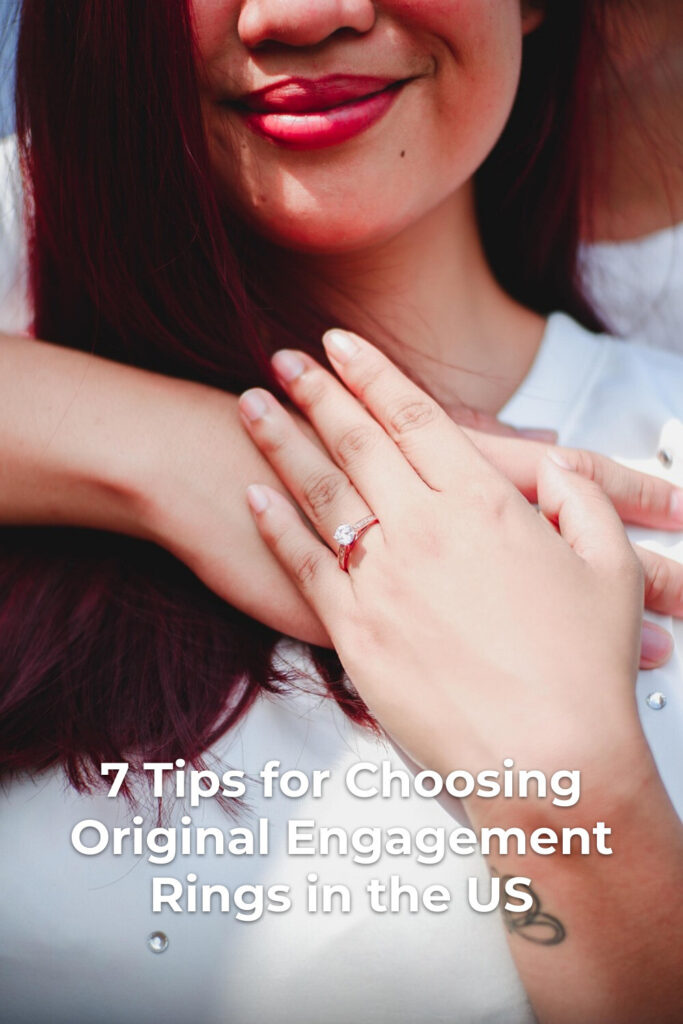 Original engagement rings close-up of woman showing ring on chest with red lipstick and small wrist tattoo