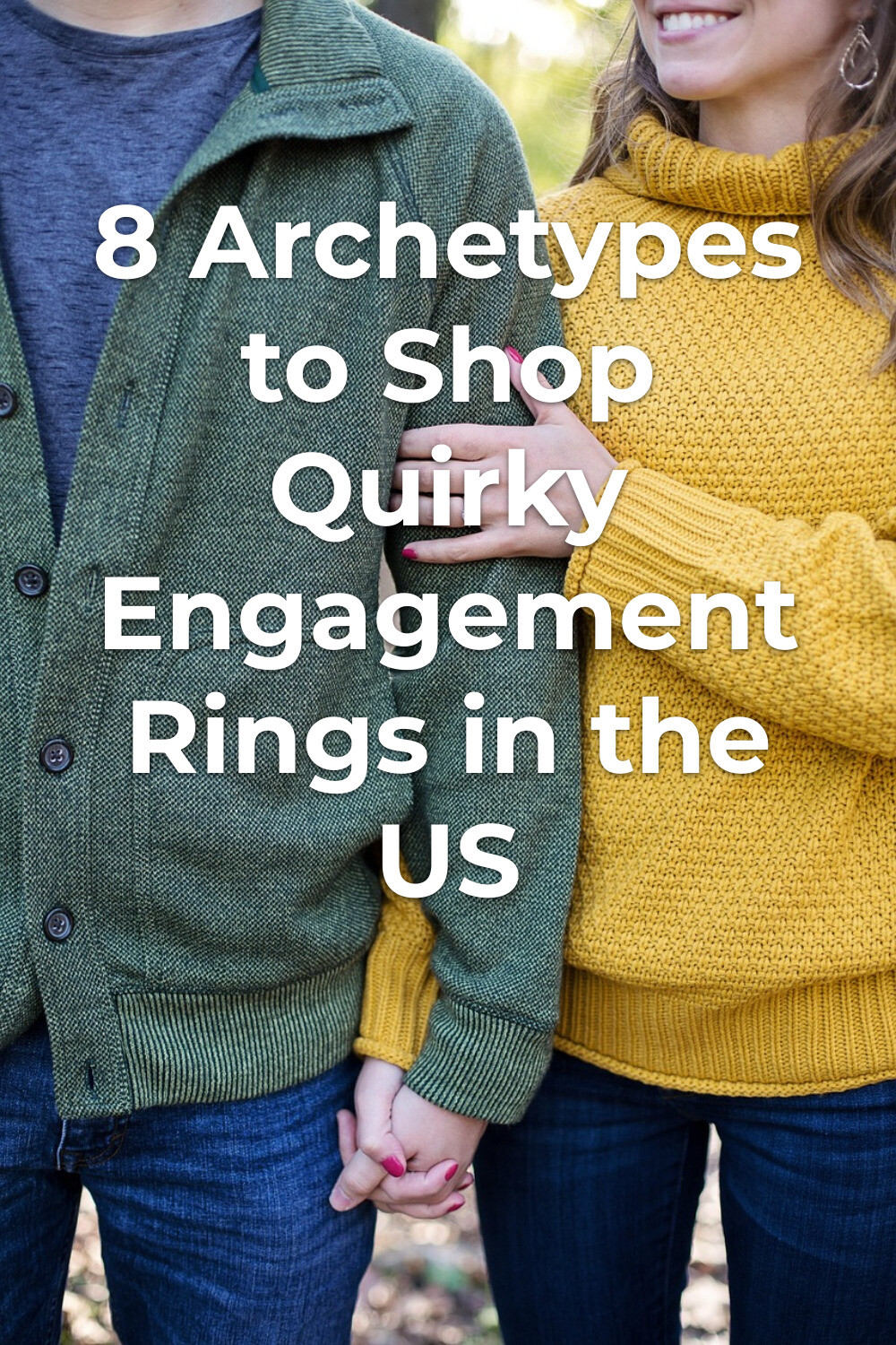 Couple holding hands in sweaters and jeans, showing quirky engagement rings in a stylish, intimate moment