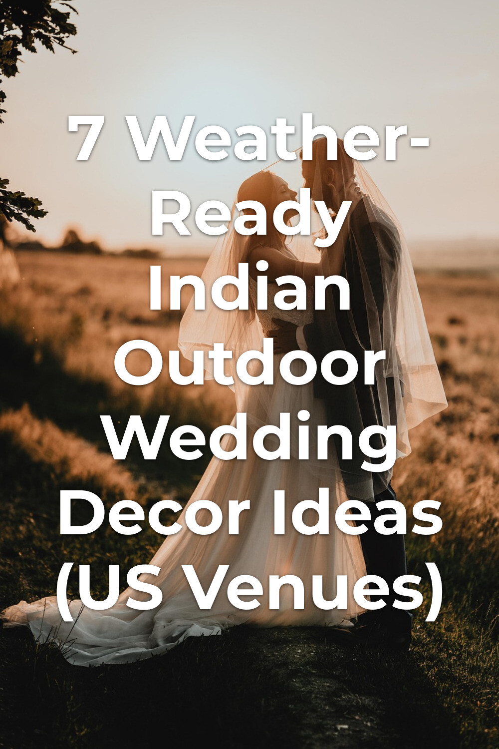 Indian outdoor wedding decor with bride in white veil facing groom in dark suit at sunset field ceremony