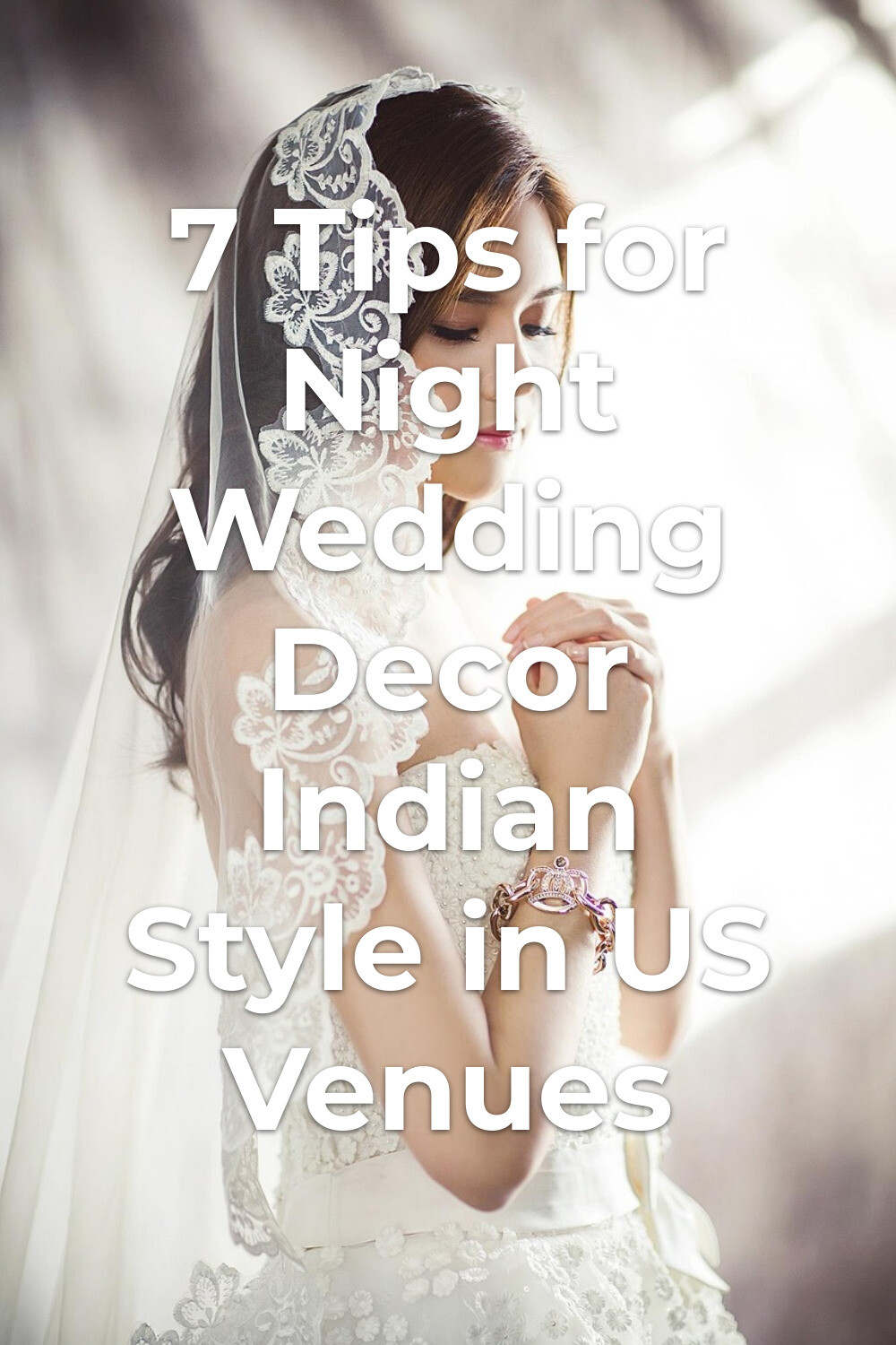 Night wedding decor Indian inspiration as bride in white dress with lace veil and bracelet poses by a bright window