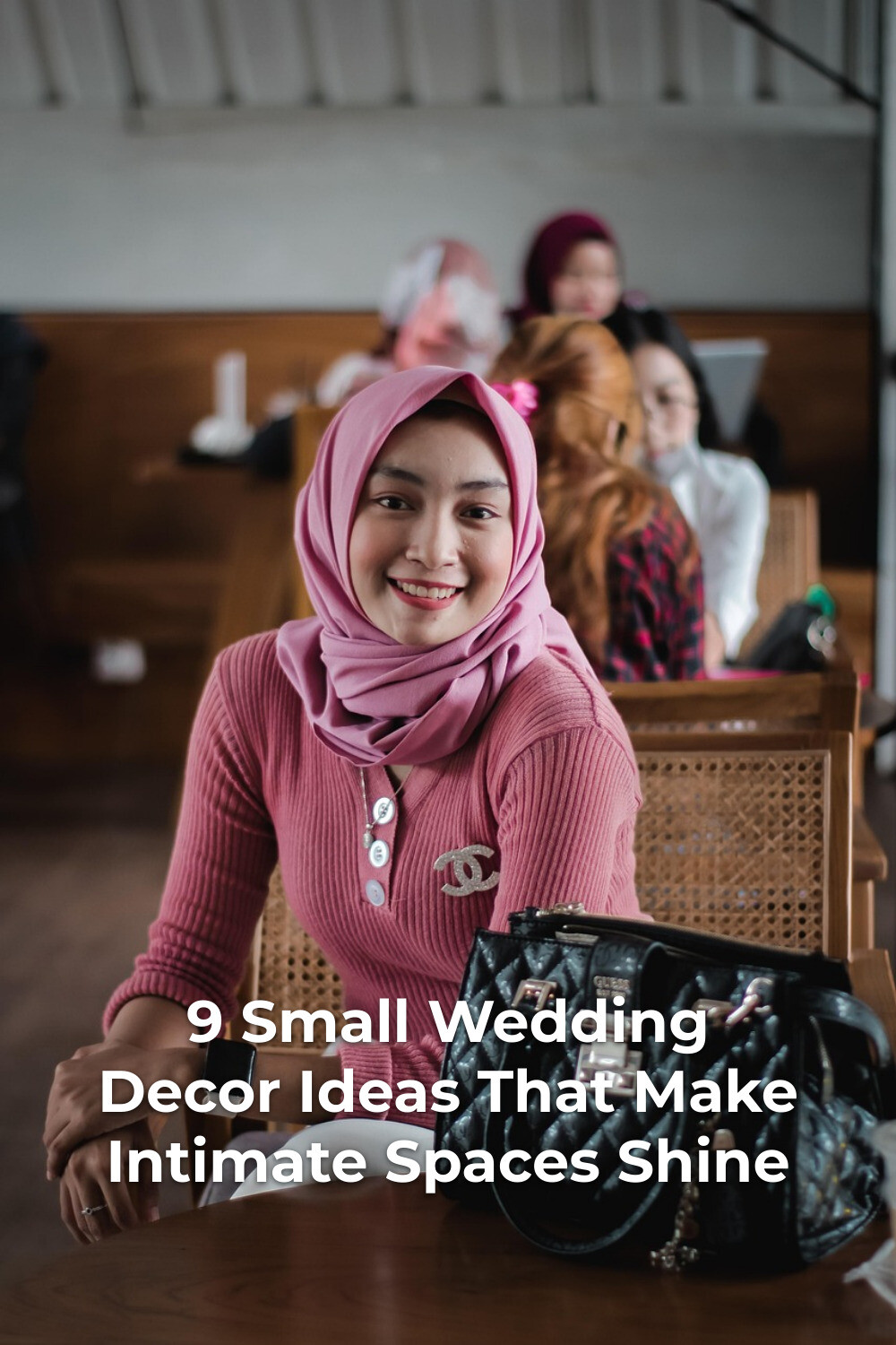 Small wedding decor planning meeting with woman in pink headscarf seated at table with handbag in foreground