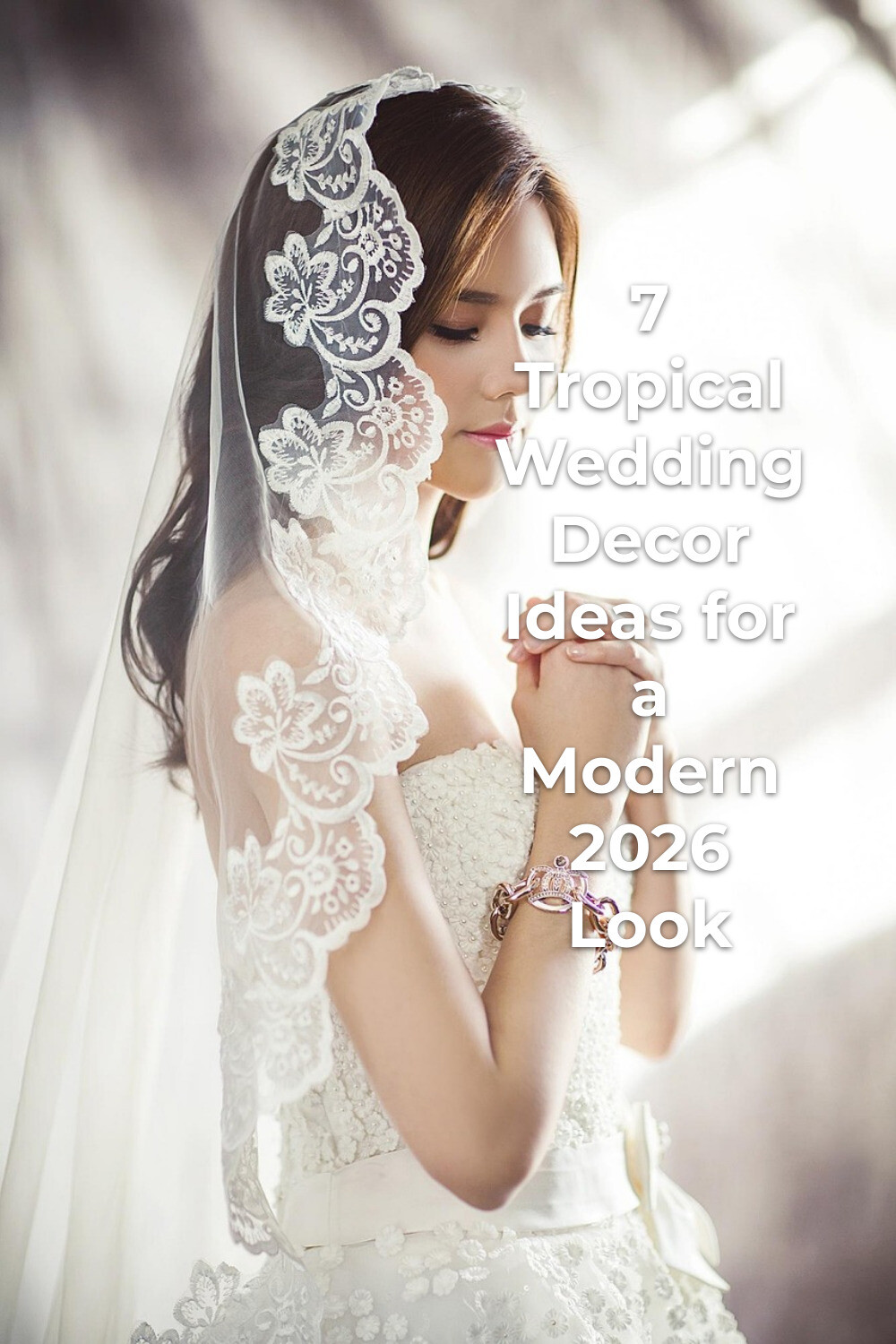 Tropical wedding decor bride in white dress and lace veil with clasped hands and bracelet