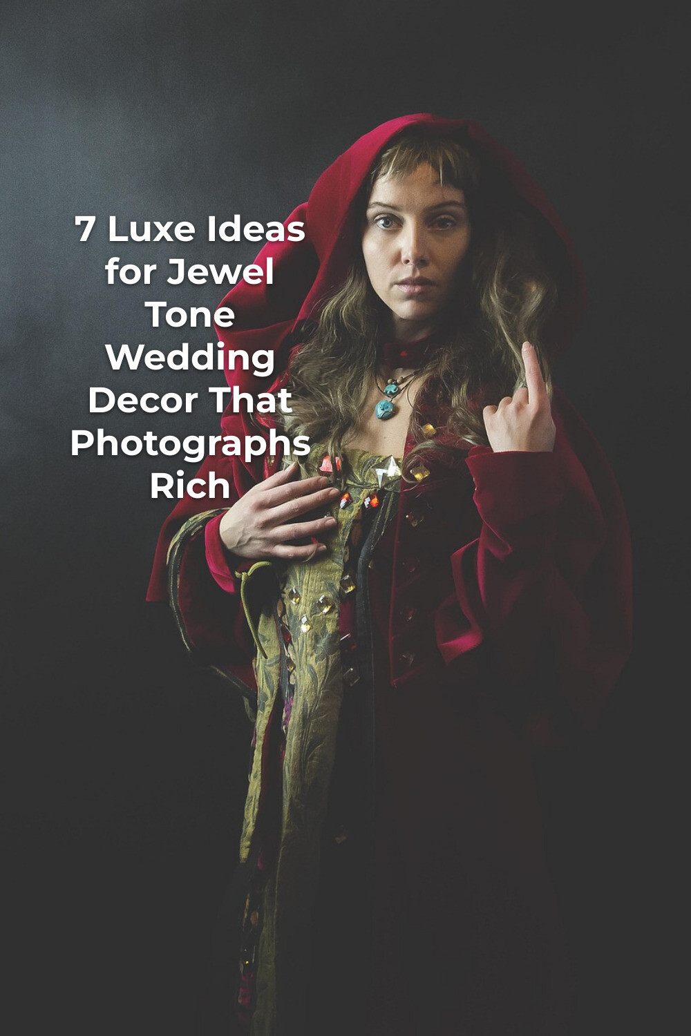 Luxurious Jewel Tone Wedding Decor Inspiration Woman in red hooded cloak against dark backdrop, luxe jewel tone wedding decor inspiration