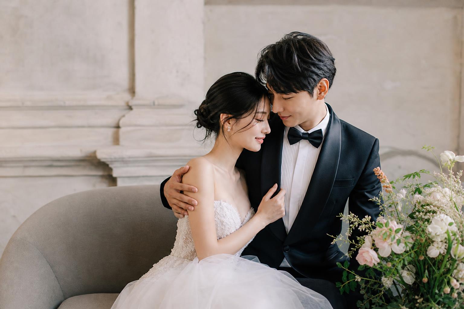 Cupal photo shoot of a stylish couple in wedding attire, blending editorial posing with soft romantic light