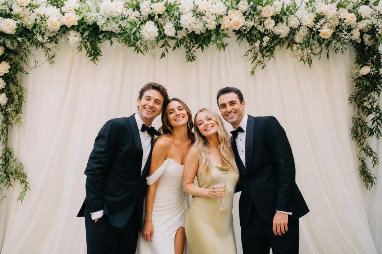 Elegant wedding photo booth backdrop with soft draped fabric and romantic neutral tones at a reception