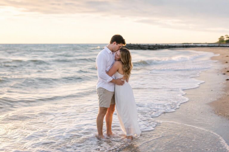 Romantic couple walking barefoot at sunset, wearing airy white outfits—beach photo shoot ideas with an effortless golden glow