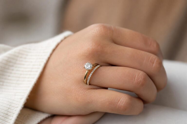 Classic white gold wedding ring sets with solitaire engagement ring and matching diamond band on a neutral background