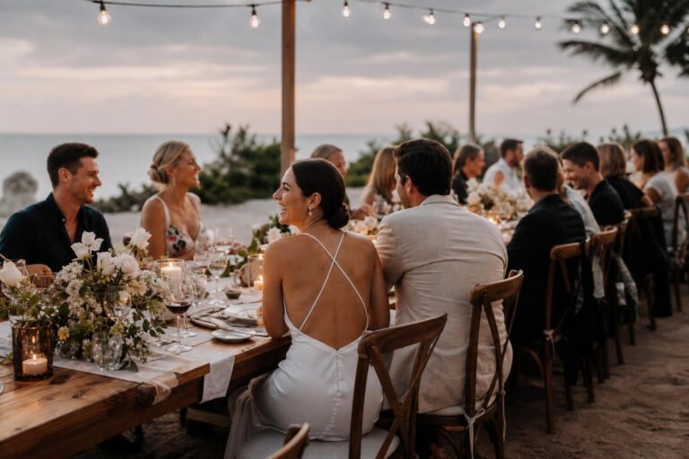 Elegant wedding rehearsal dinner tablescape with candlelight, soft florals, and refined place settings in a private dining room
