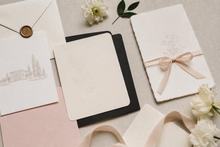 Modern wedding invitations suite with minimalist typography, neutral cards, and elegant envelope on a bright tabletop
