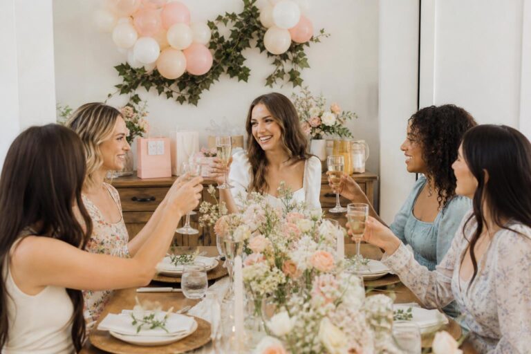 Small bridal shower ideas with an intimate garden brunch table, blush florals, candles, and elegant place settings