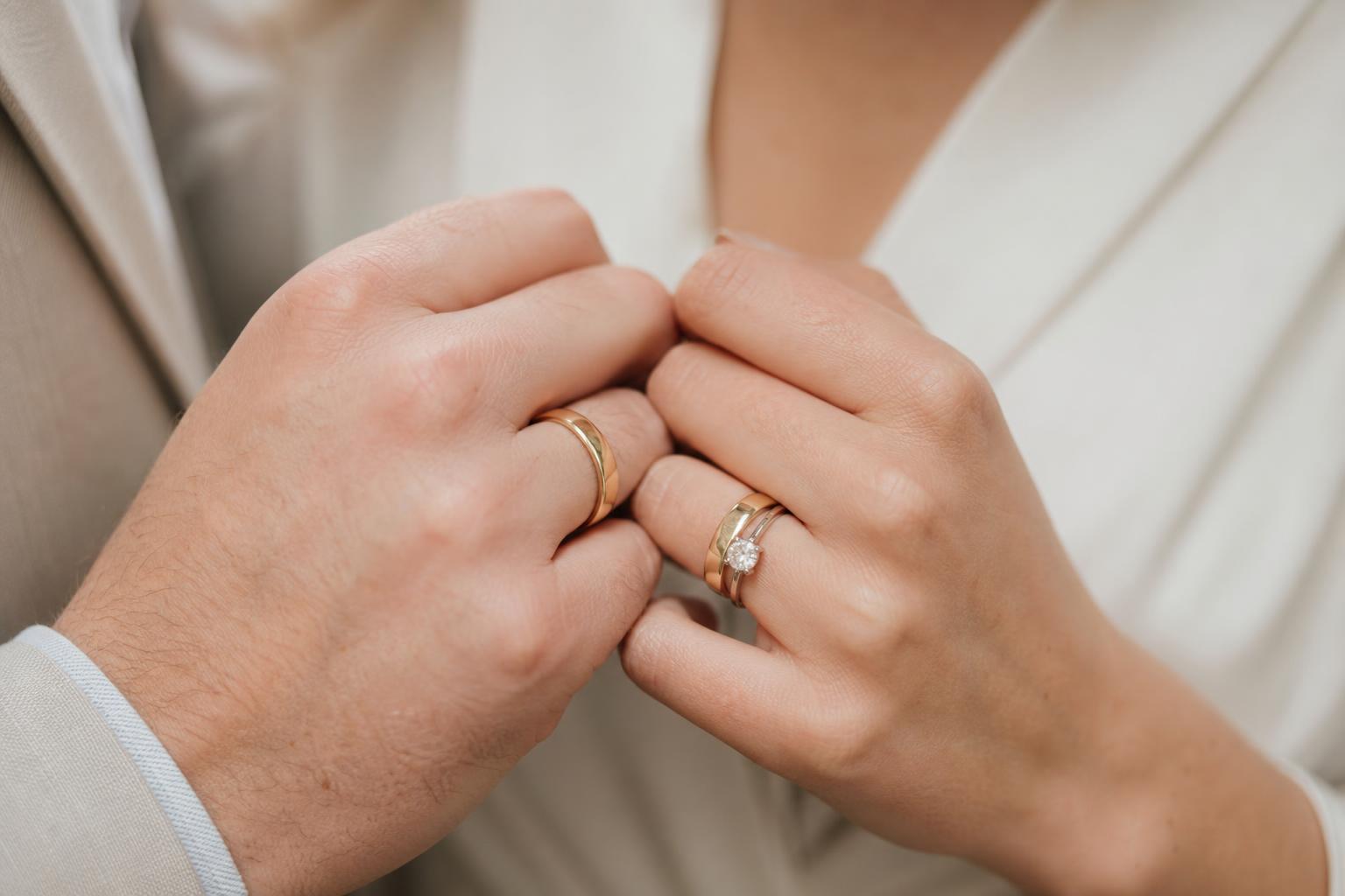 Matching wedding bands in yellow gold with a polished finish, photographed side by side for a timeless couple look