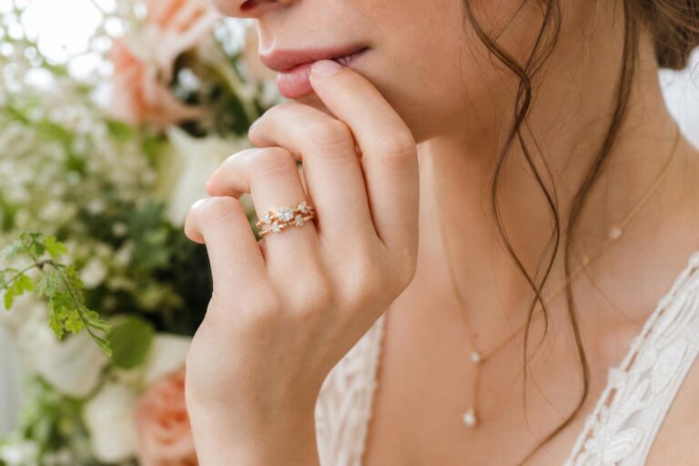 Whimsical wedding ring with delicate floral vine band in yellow gold, sparkling diamonds in soft natural light