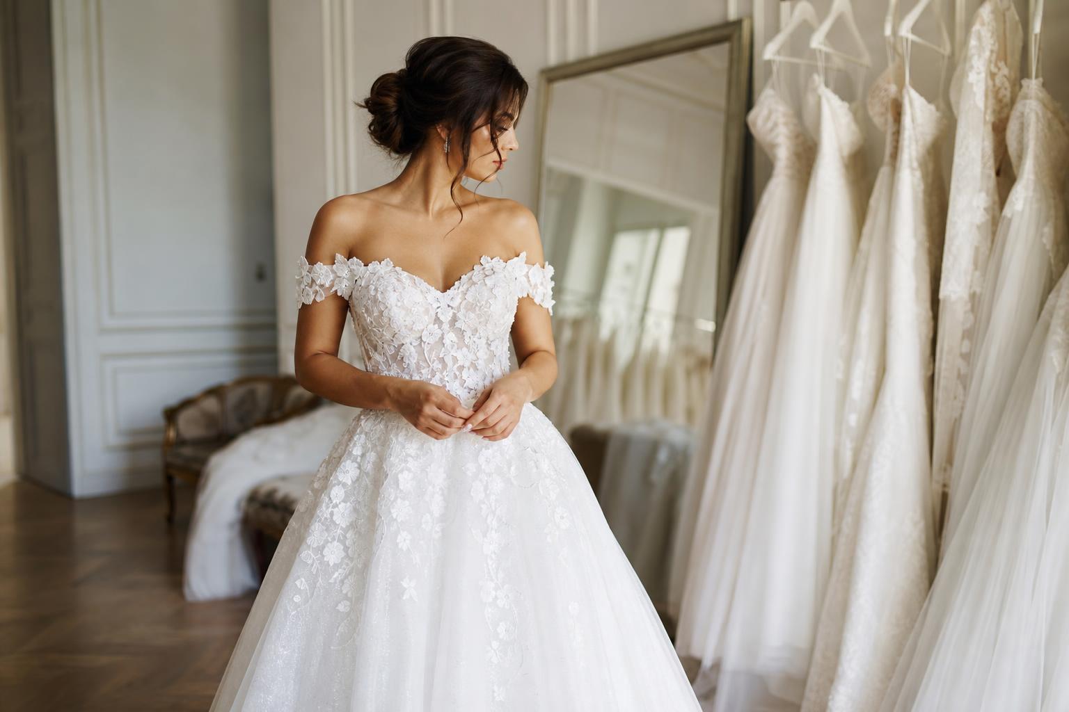 White bridal dresses in satin and lace styled for elegant wedding settings