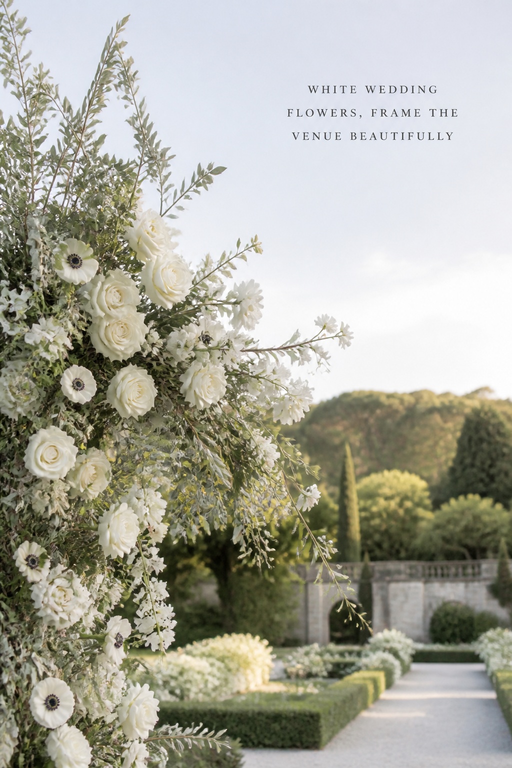 white wedding flowers framing a garden ceremony with an airy asymmetrical arch