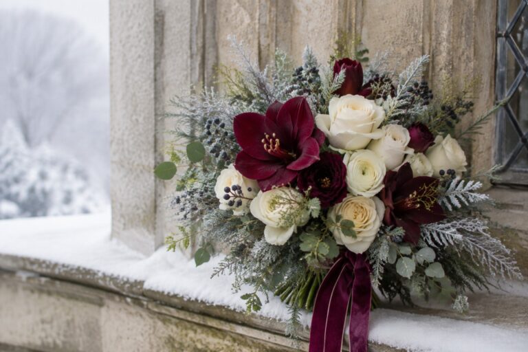 Winter wedding bouquet with ivory roses burgundy amaryllis and evergreen